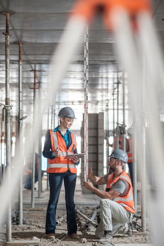 construction-engineers-measure-building-progress
