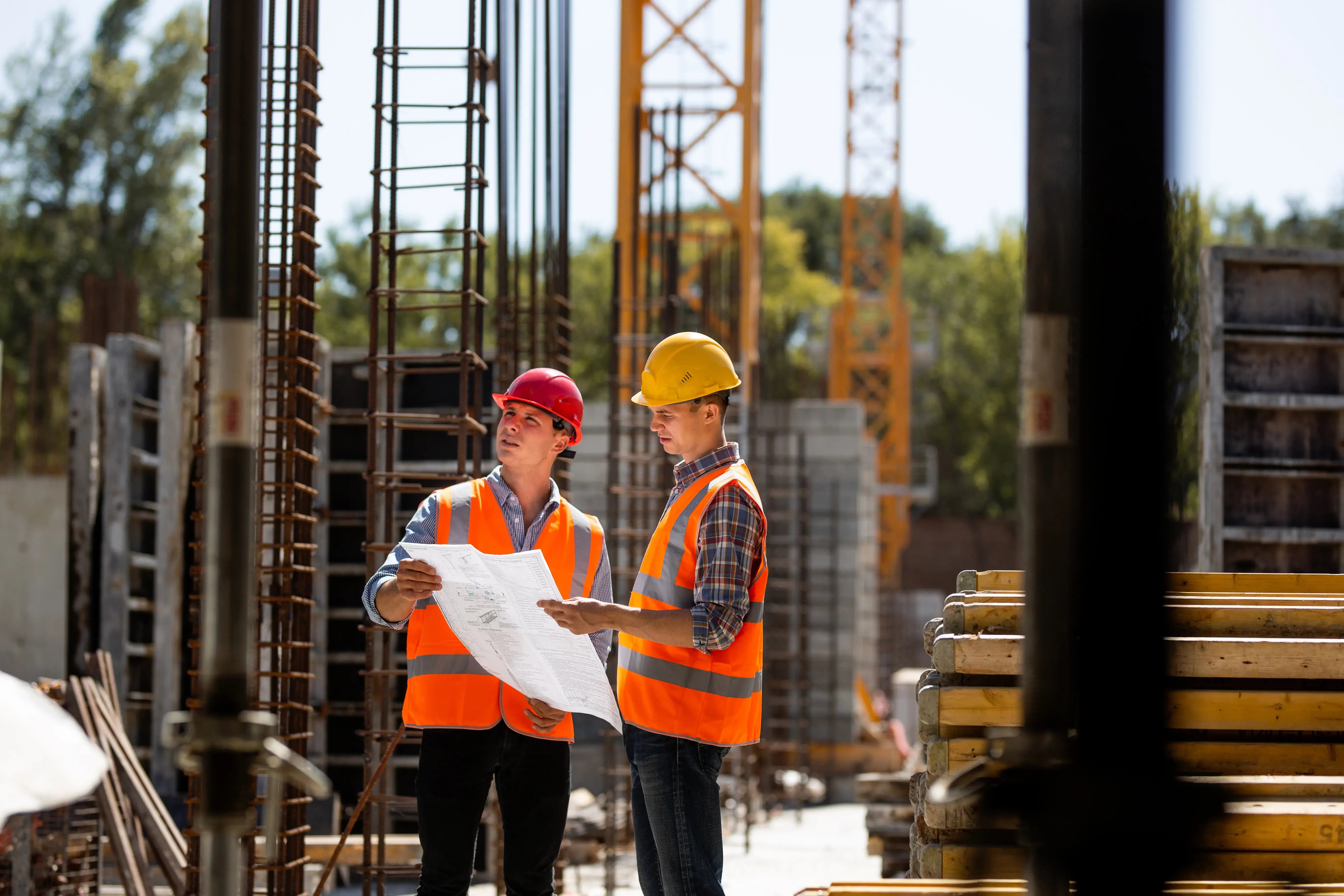 construction-workers-reviewing-blueprints-at-a-construction