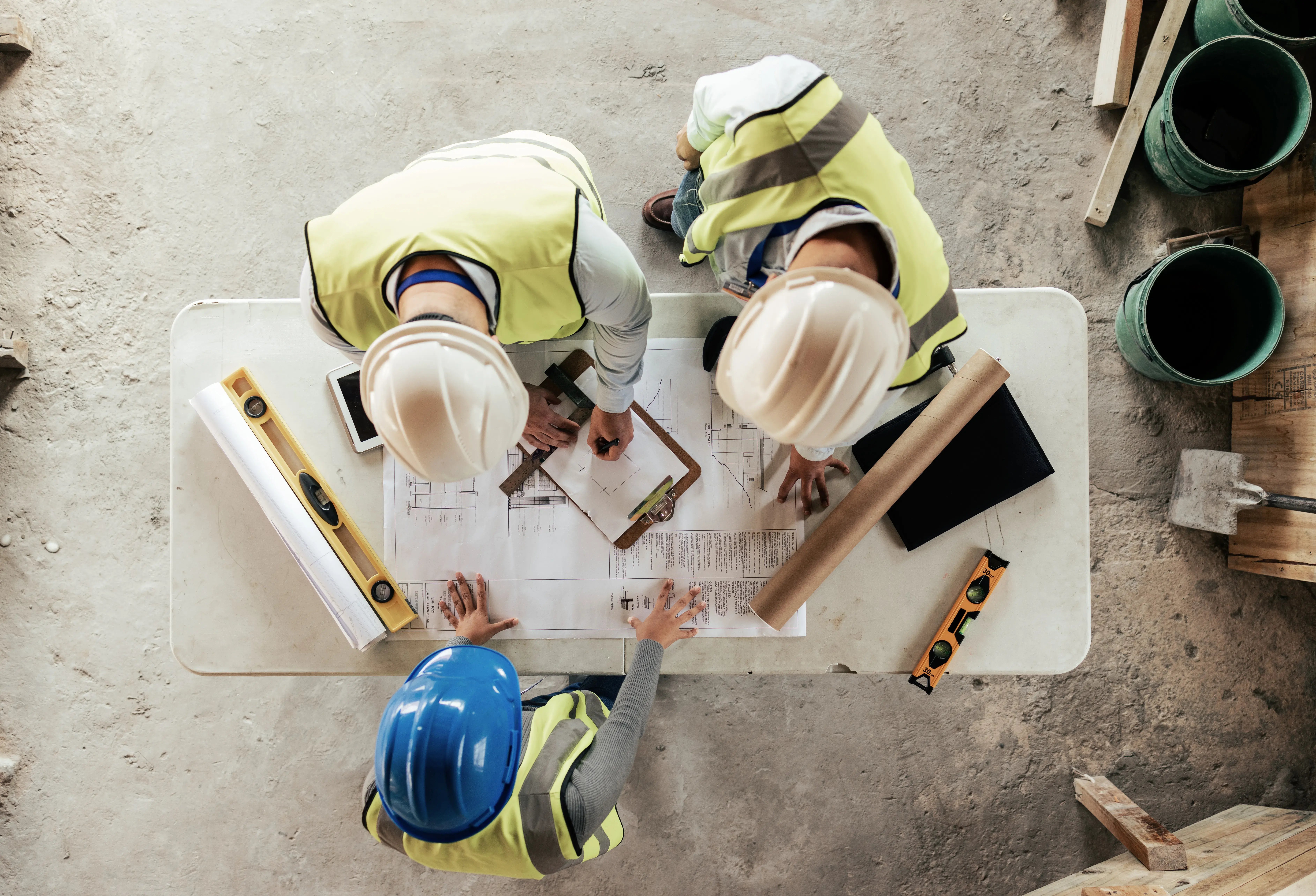 construction-workers-reviewing-blueprints-on-site