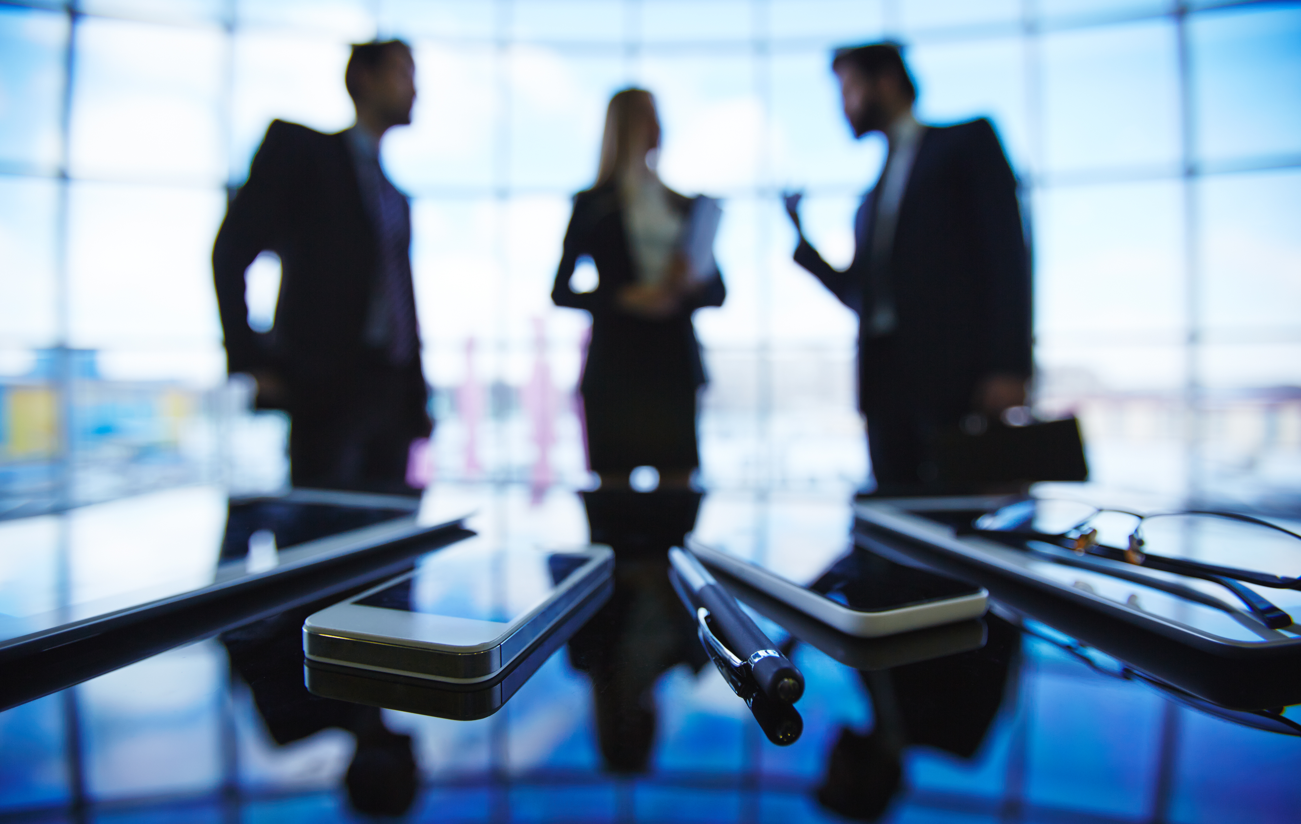 Three business professionals in discussion, representing the decision-making process around what does incorporated mean in business and choosing the right company structure.